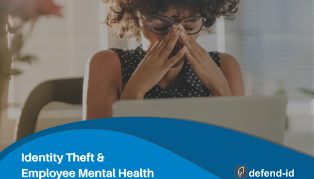 Employee stressed at laptop, illustrating the mental health impact of identity theft in the workplace.
