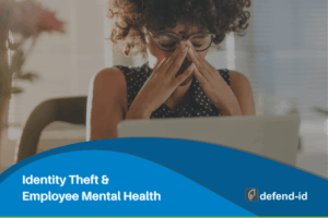 Employee stressed at laptop, illustrating the mental health impact of identity theft in the workplace.