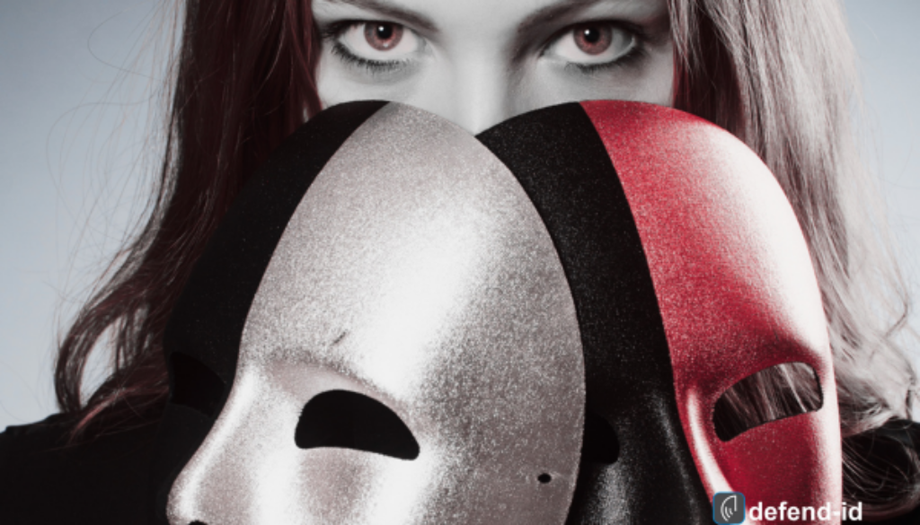 A person holding two metallic masks in front of their face, symbolizing identity theft and the disguises used by cybercriminals to steal personal and employee information.