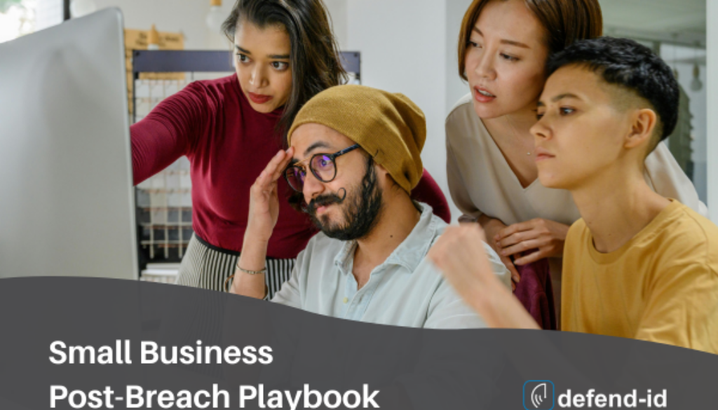 Small business team collaborating on a post-breach playbook at a computer with defend-id branding