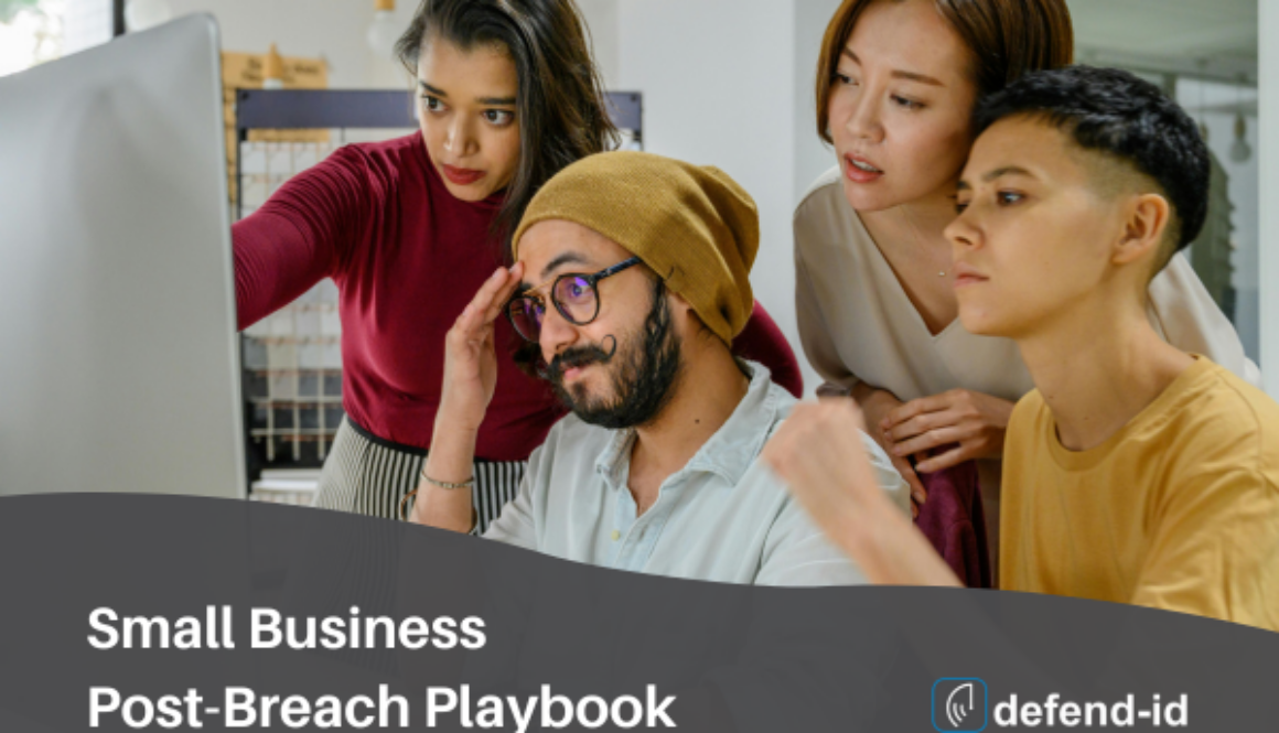 Small business team collaborating on a post-breach playbook at a computer with defend-id branding